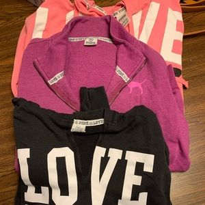 Three Victoria pink hoodies